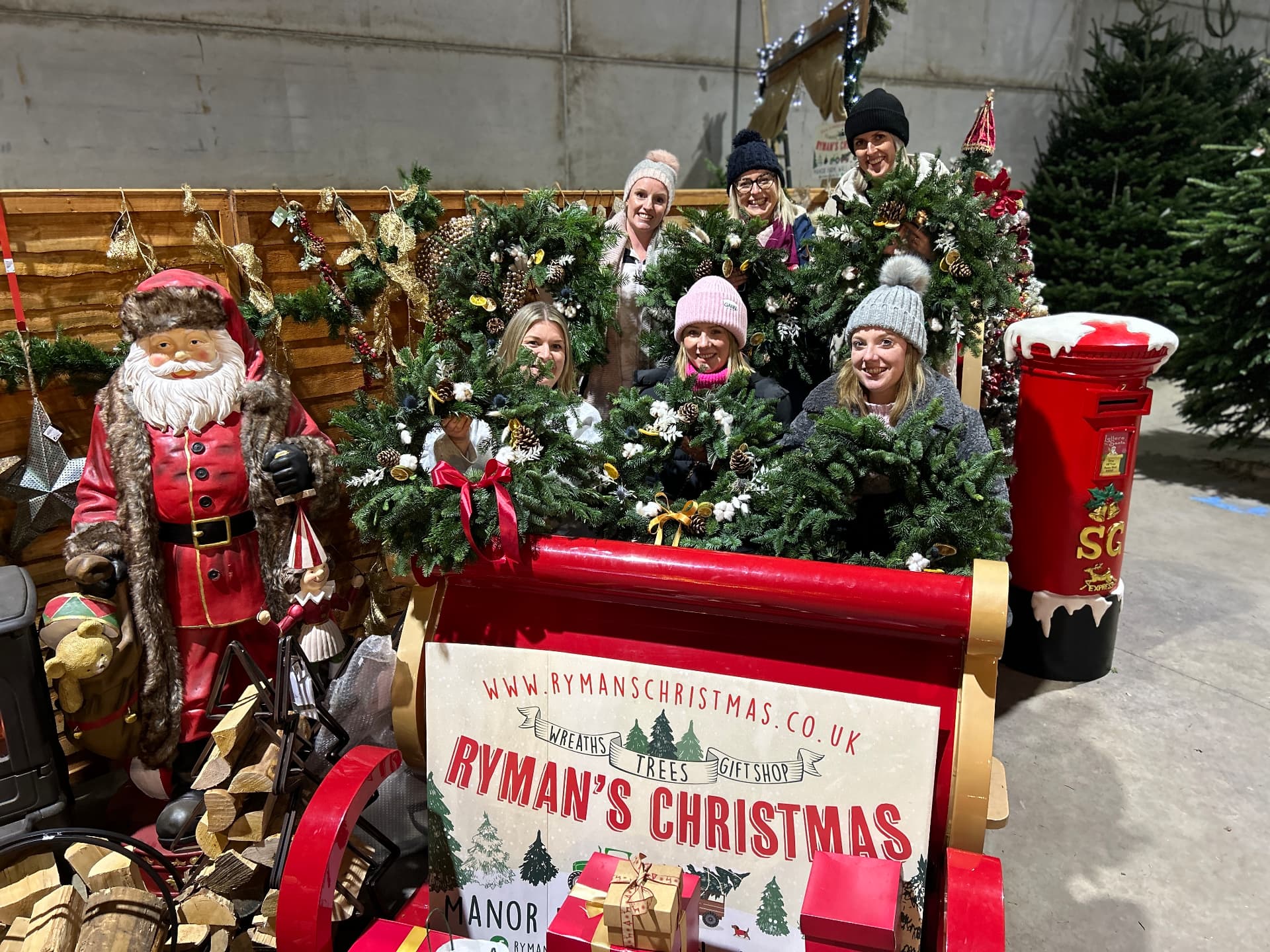 The Rymans Christmas team with handmade wreaths, festive sleigh and Santa display